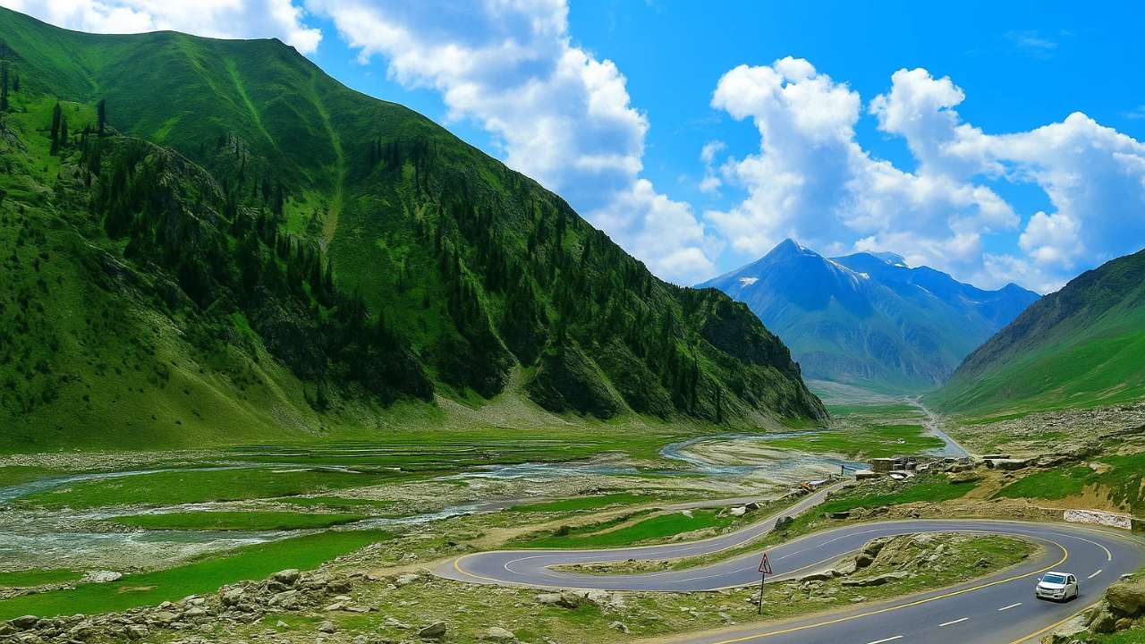 Adventure GB Babusar Top tour with winding mountain road and green valleys