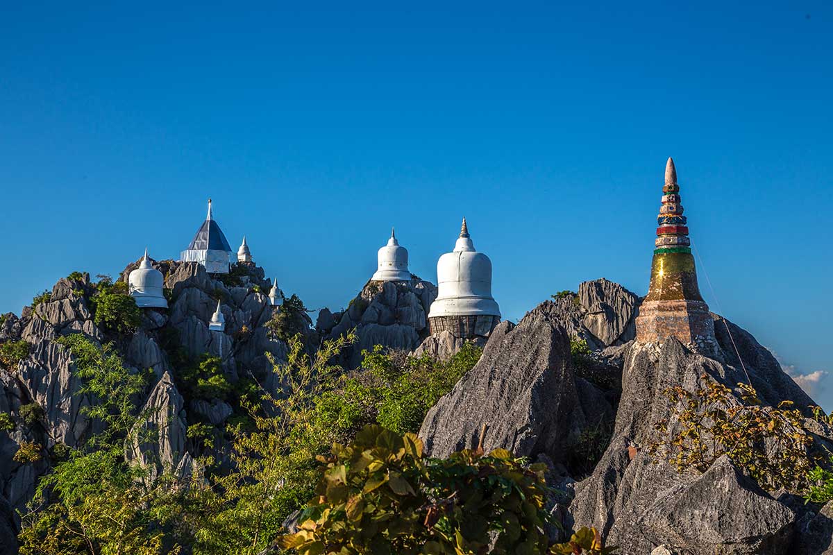 Aerial view of Thai temple with mountains