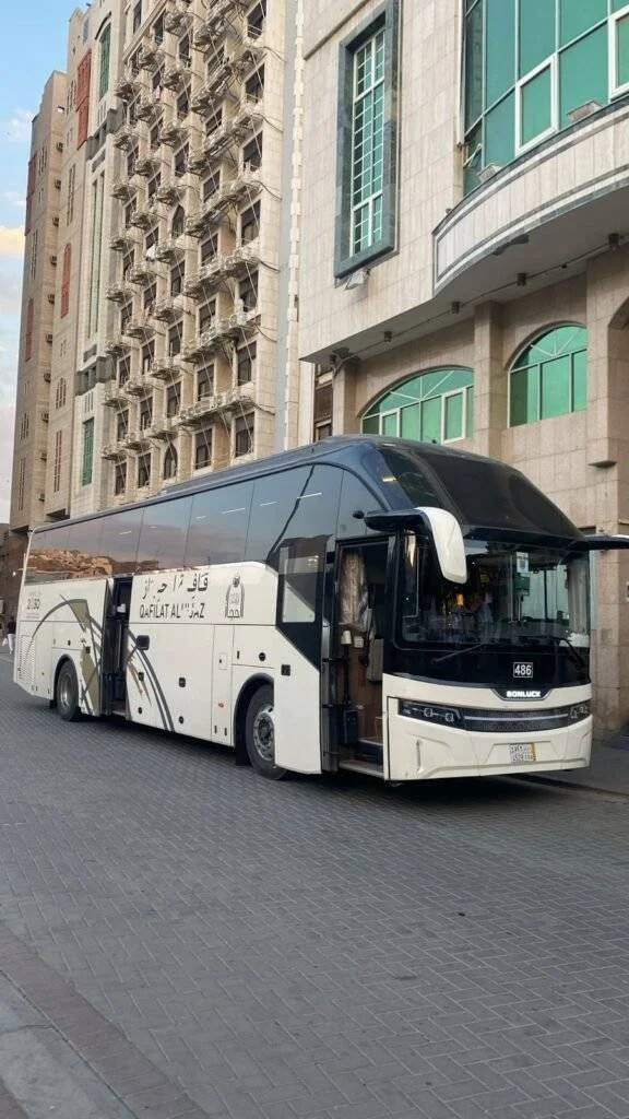 Luxury AC bus waiting at Jeddah airport for Umrah pilgrims transfer to Makkah hotel