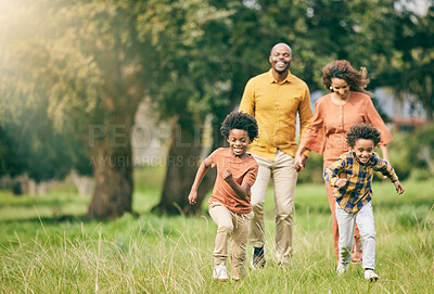 Happy family, running and children at a park with parents, freedom and  playing in nature together. Love, energy and excited kids run in a forest  with mother, father and bonding, games and