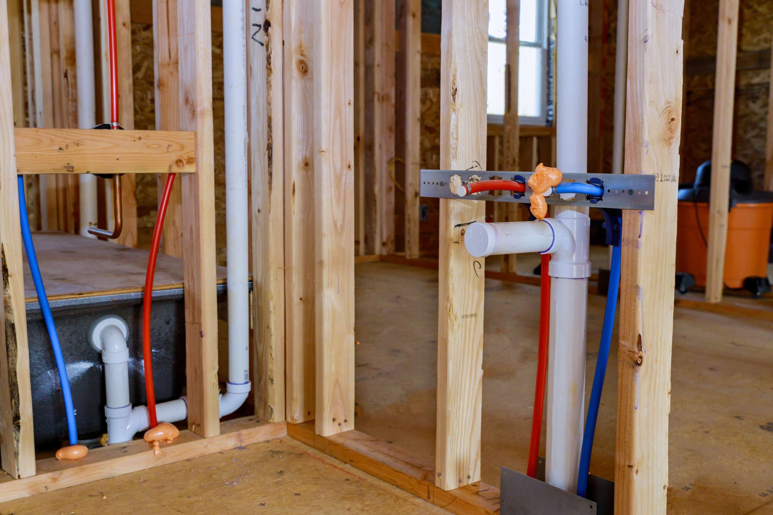 Rough-in plumbing behind walls