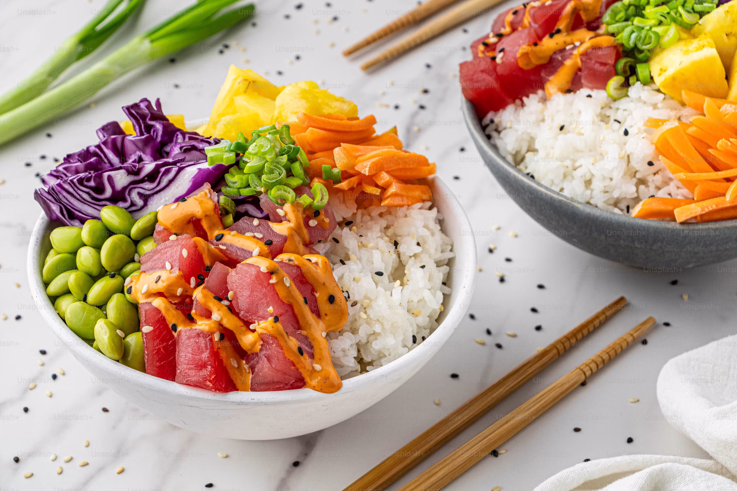 Fresh salmon poke bowl with rice edamame cabbage carrots mango