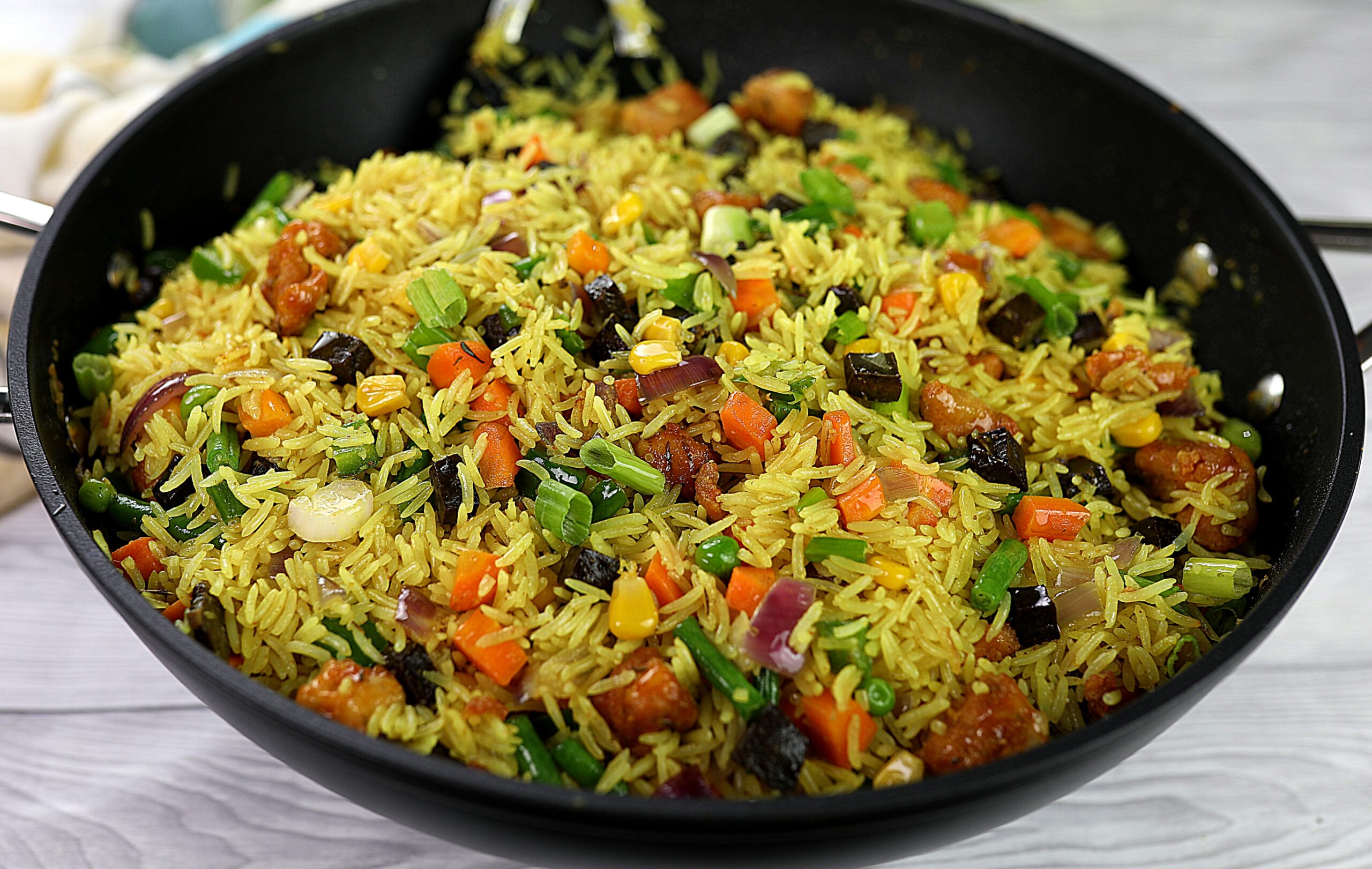 Fried rice made with parboiled rice, liver, green peas, carrots, green beans, chicken stock, soy sauce and mixed spices - RoyalRoom Restaurant Lagos