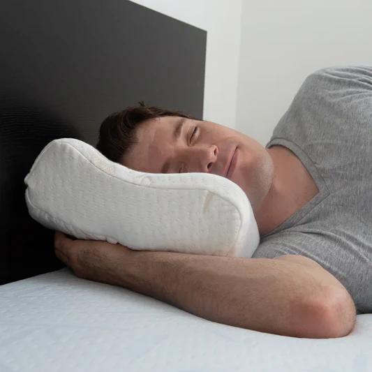 Man sleeping peacefully on side with orthopedic memory foam pillow