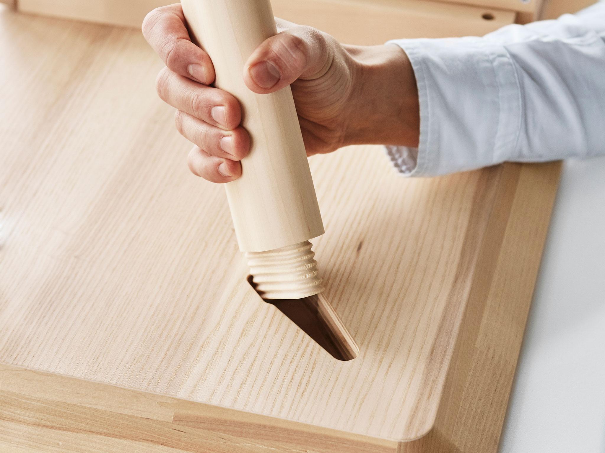 Hands assembling IKEA flat-pack furniture