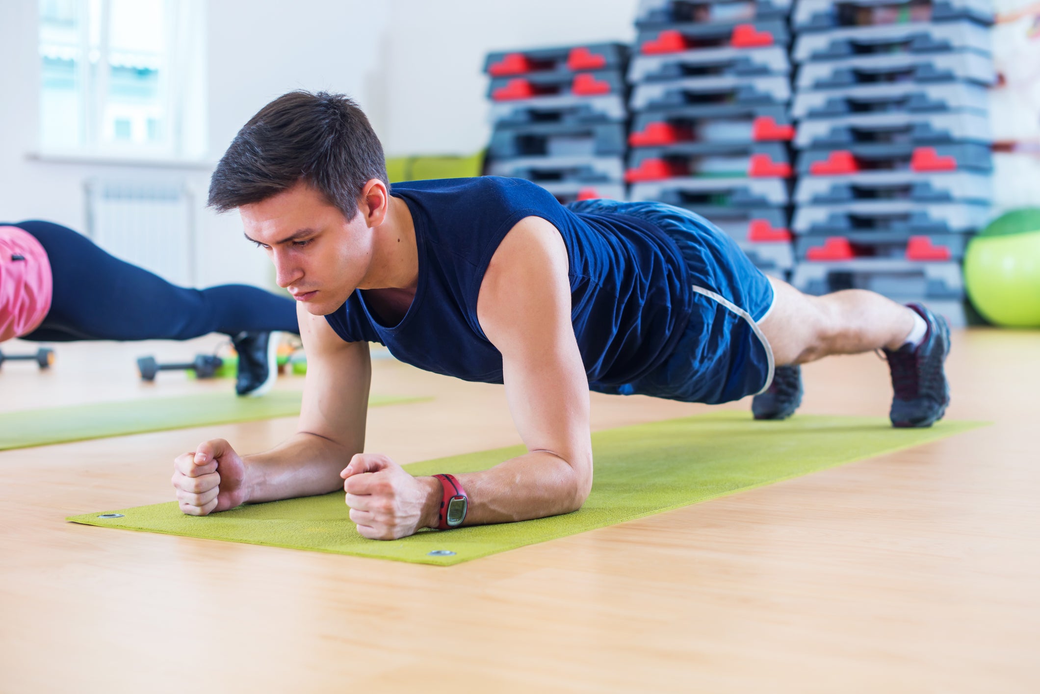 Person performing plank with dumbbell row exercise for core and back strength