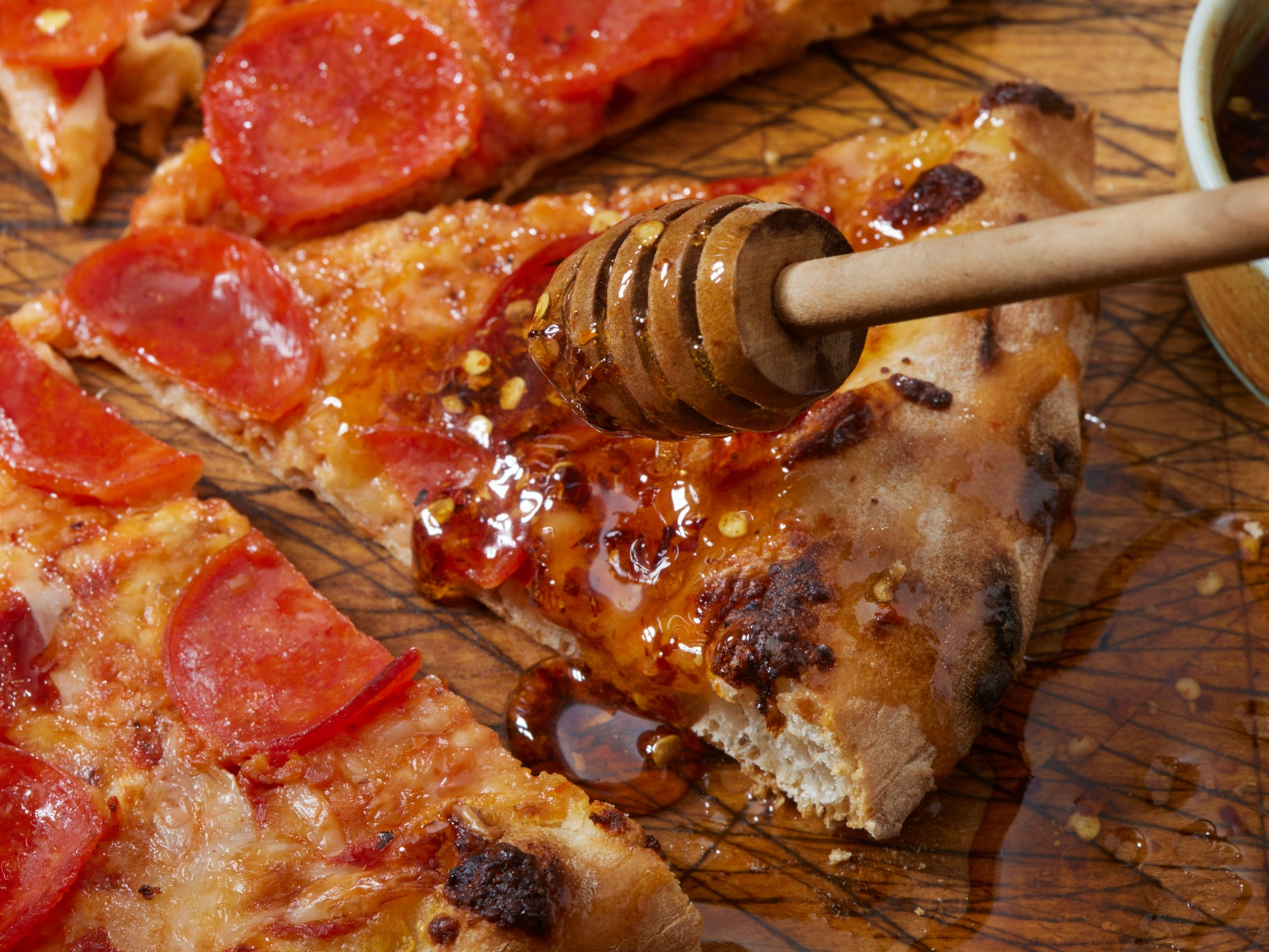 Hot honey drizzled on pepperoni pizza swicy food trend 2026