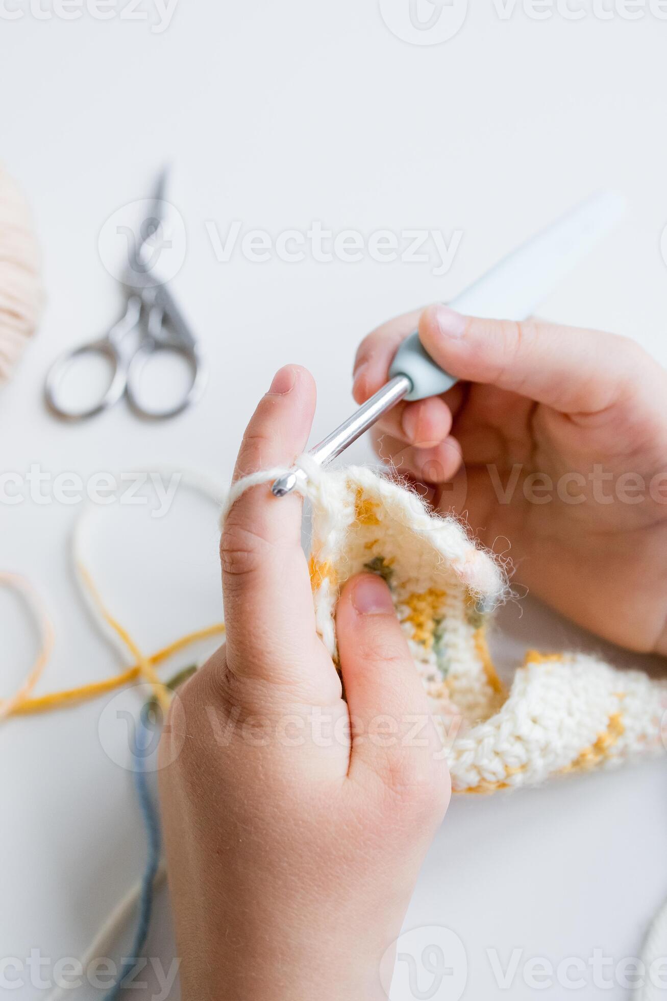 Close up of hands crocheting a colorful pattern with crochet hook and yarn 61377019 Stock Photo at Vecteezy