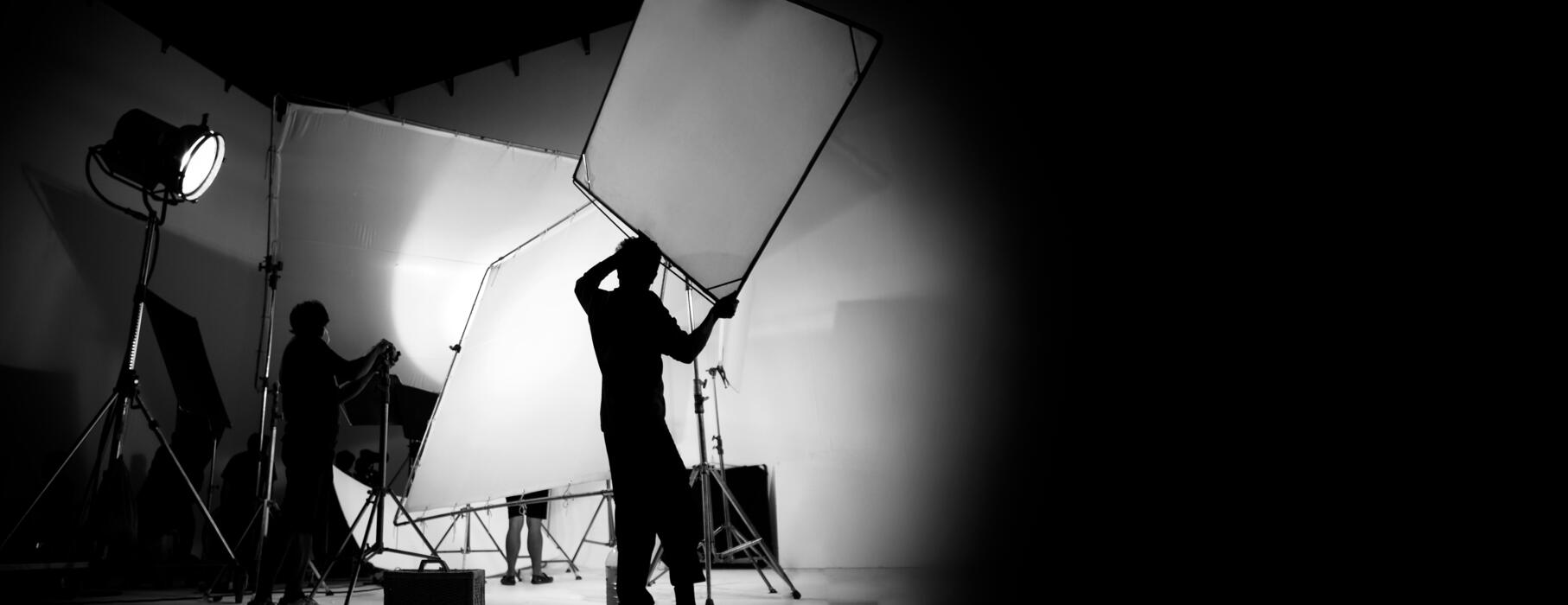 Commercial photography crew adjusting lighting on set