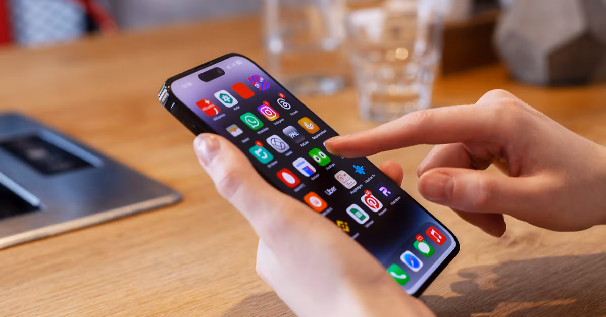 Daily iPhone Use with iOS 18 Features Person using iPhone with new iOS features in daily life