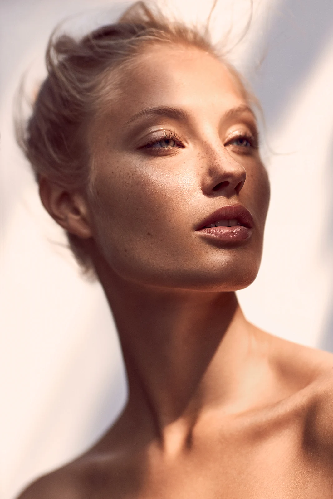 Radiant portrait of a confident woman with natural skin in soft natural light