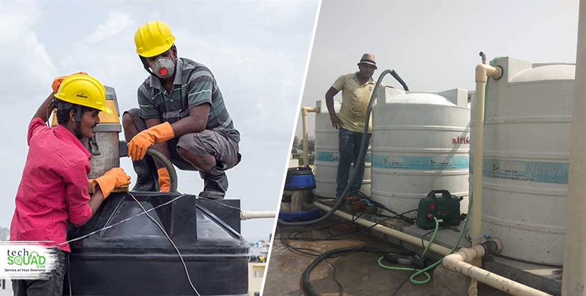 Technicians cleaning overhead water tanks on rooftop