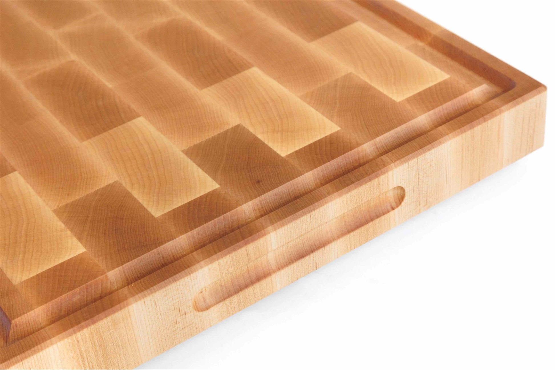 Close up of end grain maple cutting board showing tight checkerboard pattern and creamy wood color