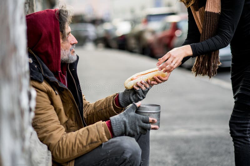 Volunteer offering food to a neighbor on the street