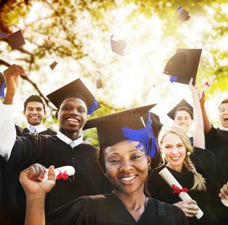 African graduates celebrating with caps in the air