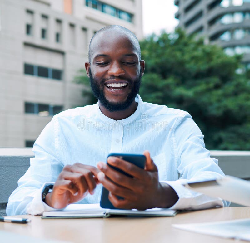 African entrepreneur smiling while using smartphone for customer service