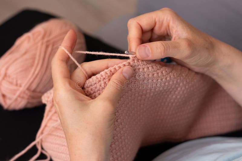 A woman crochets at home stock image. Image of focus - 388482577
