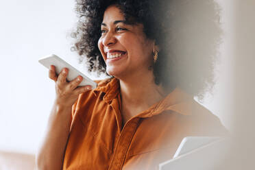 Happy businesswoman managing customer service on phone