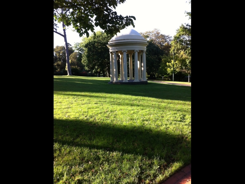 Rotunda pavilion in Fitzroy Gardens surrounded by green lawns