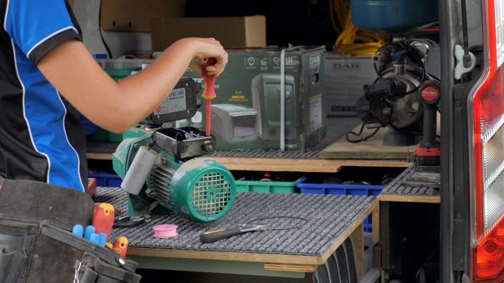 Water pump repair technician at work