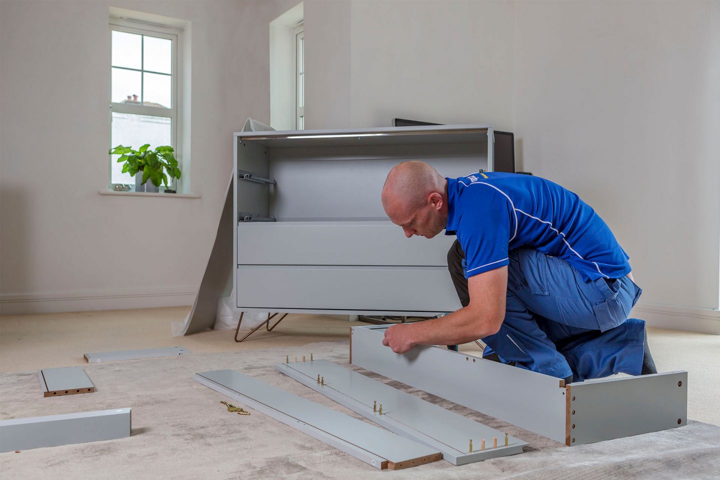 Technician assembling flat-pack furniture