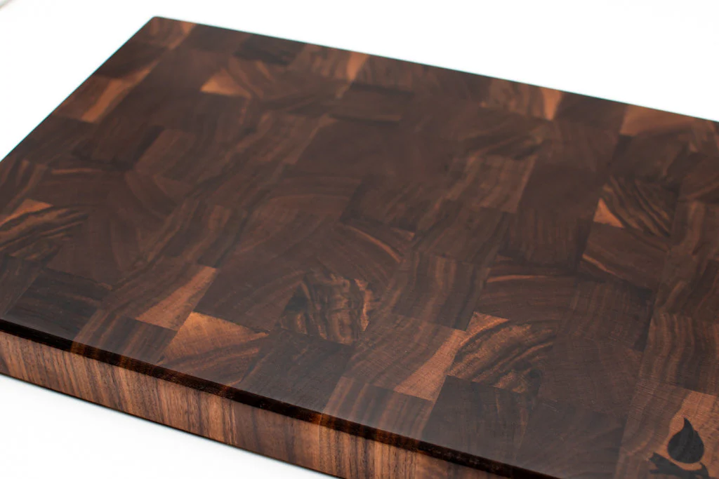 Close up of end grain walnut cutting board showing rich dark chocolate brown color and wood grain