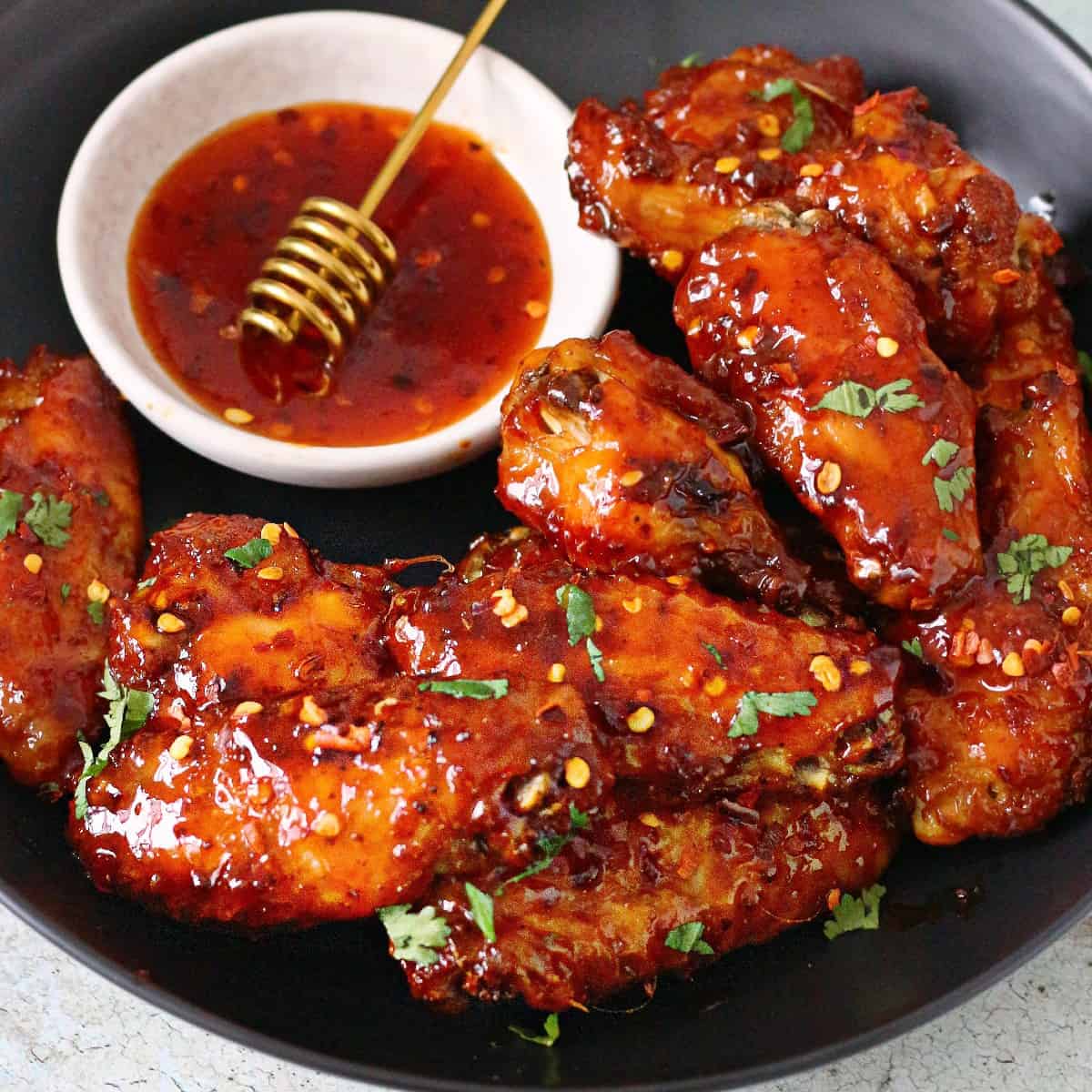 Crispy hot honey chicken wings with honey drizzle bowl sweet spicy recipe