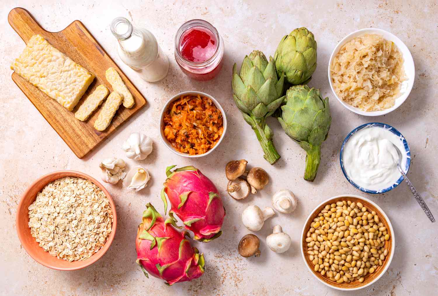 Gut-Healthy Foods for Daily Wellness Colorful gut-healthy foods including artichokes, oats, yogurt, and dragon fruit arranged on a table