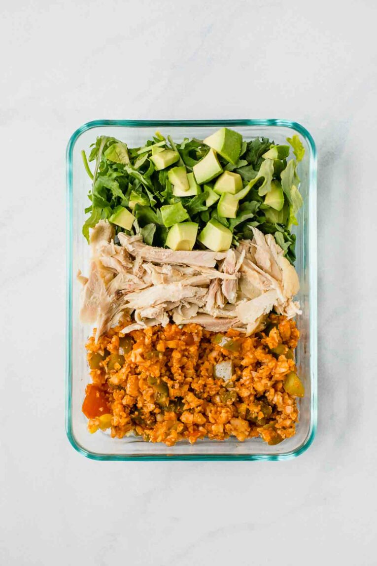 Low-carb Mexican meal prep bowl with shredded chicken avocado and cauliflower rice