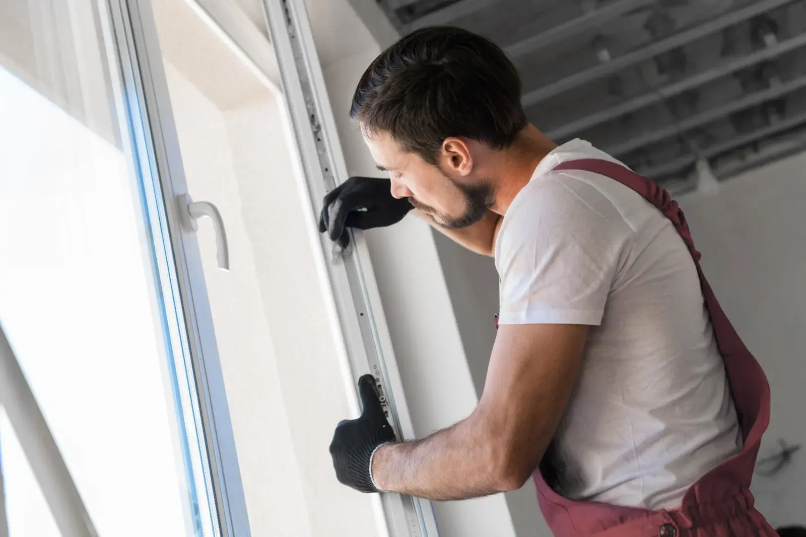 Technician repairing window frame and seal