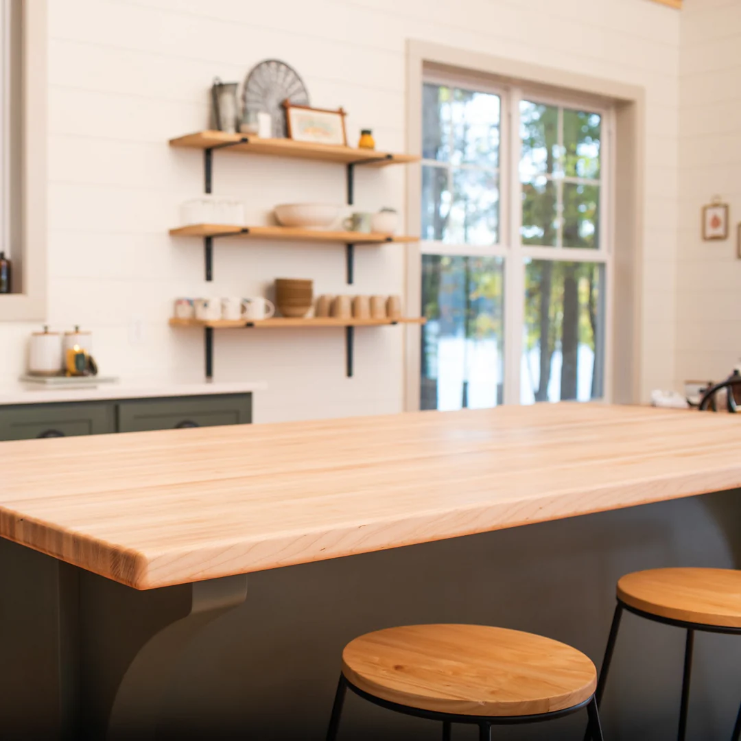 Beautiful well-maintained maple butcher block countertop showing proper mineral oil finish and water beading protection