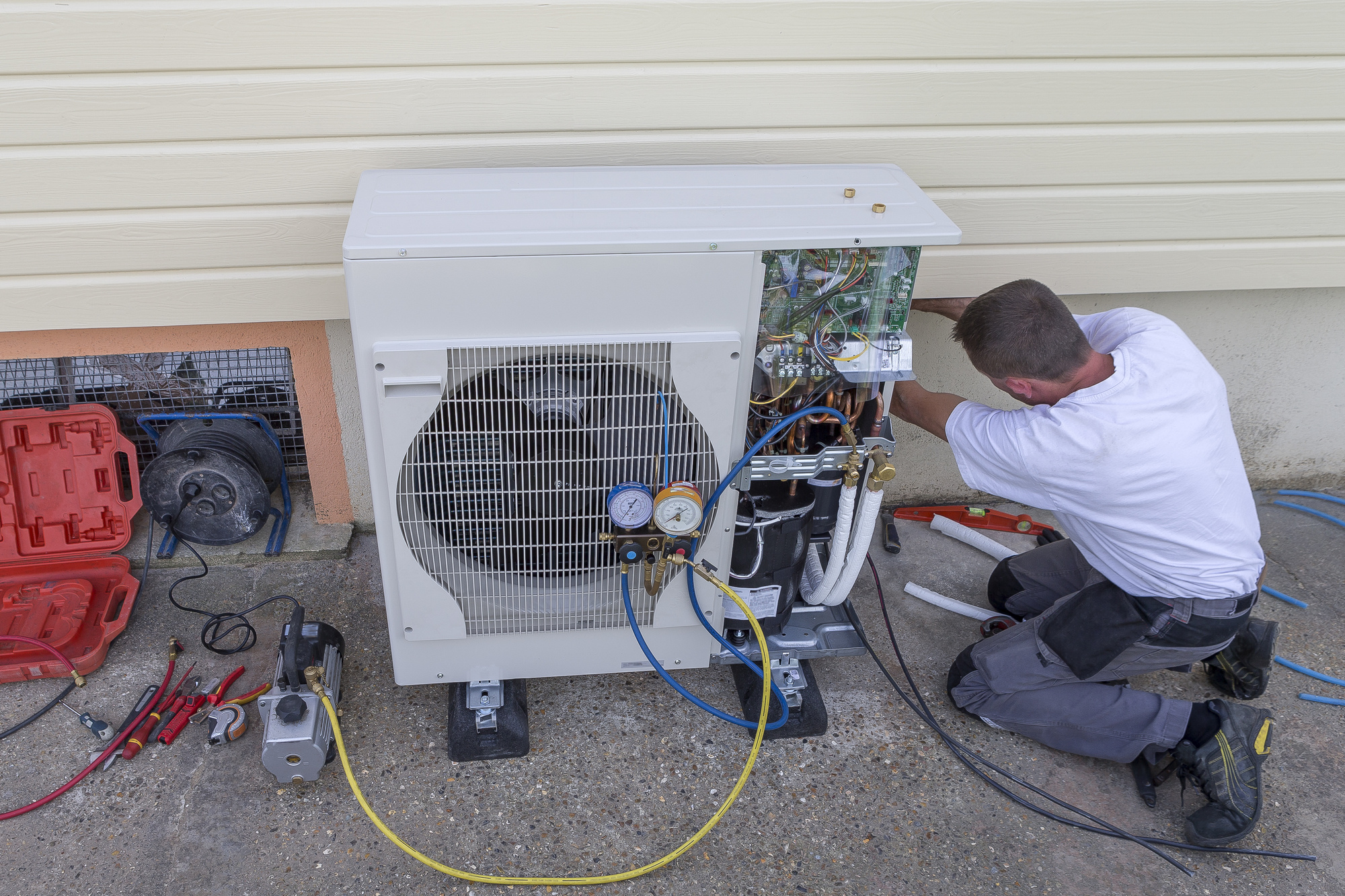 HVAC Technician Servicing Heat Pump