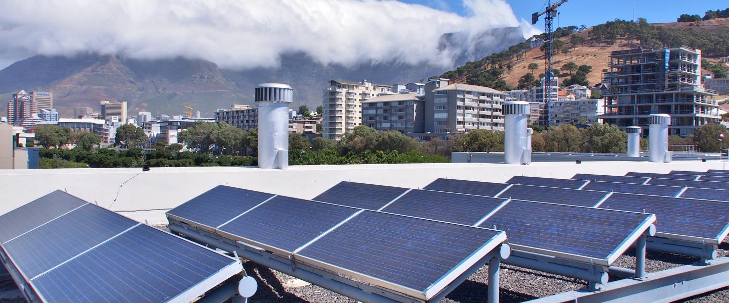 Solar panels in South Africa with cityscape