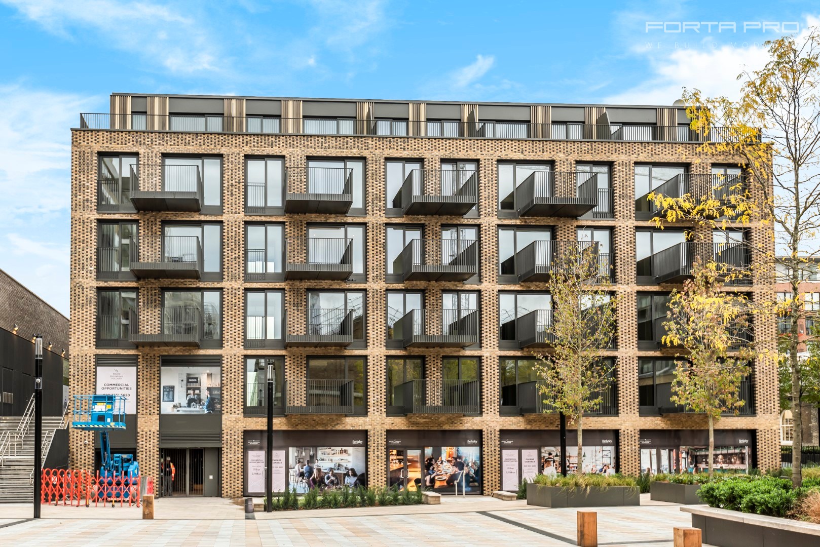 Modern multi-unit residential development with brick facade and balconies