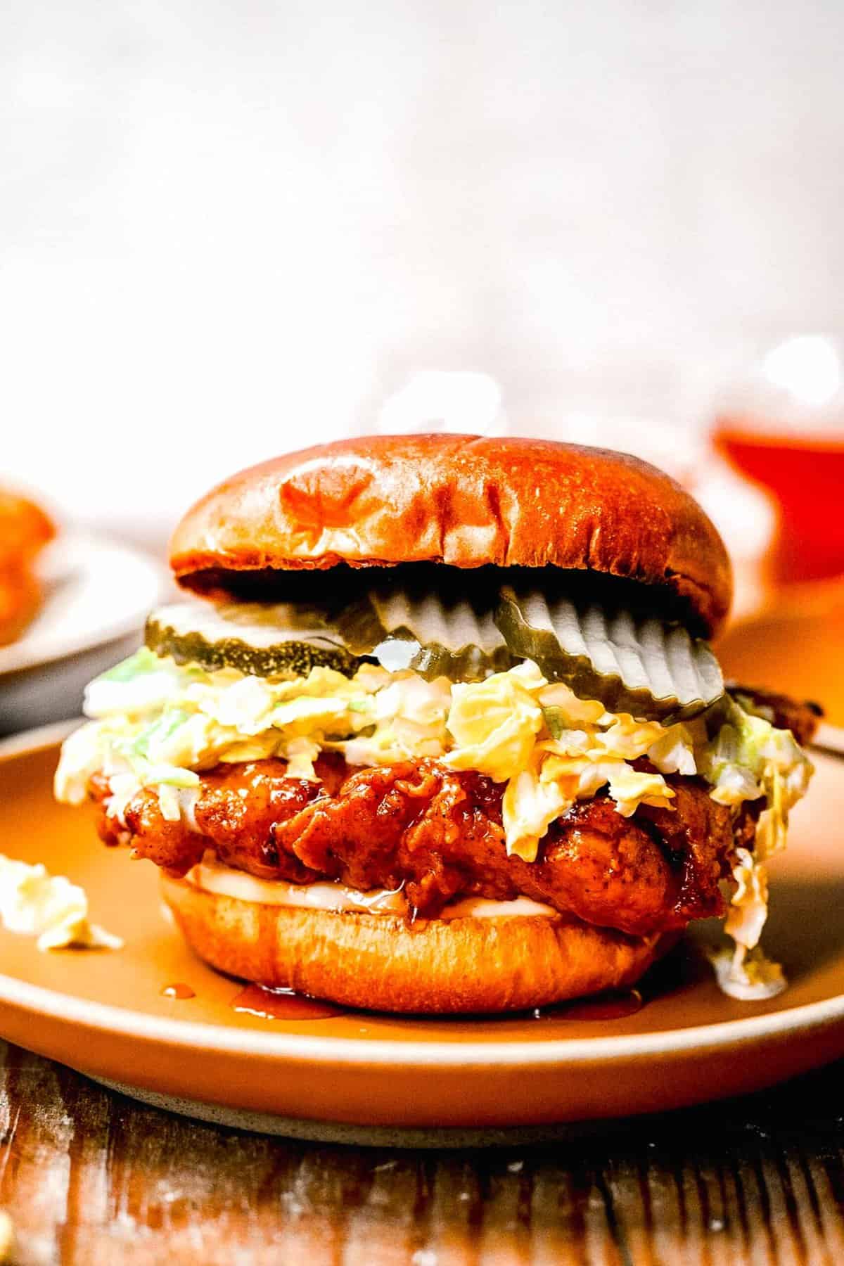 Hot honey chicken sandwich with pickles coleslaw brioche bun sweet spicy