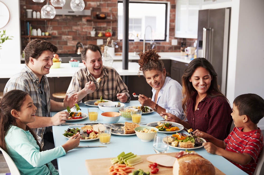 Family enjoying a healthy low-carb meal together Happy family eating a healthy low-carb dinner together at home