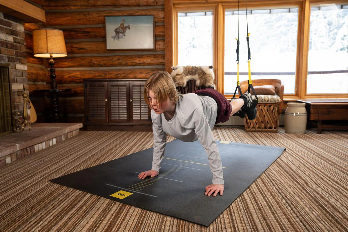 Home plank workout on yoga mat in living room Person performing a plank exercise on a yoga mat in a cozy home living room setting