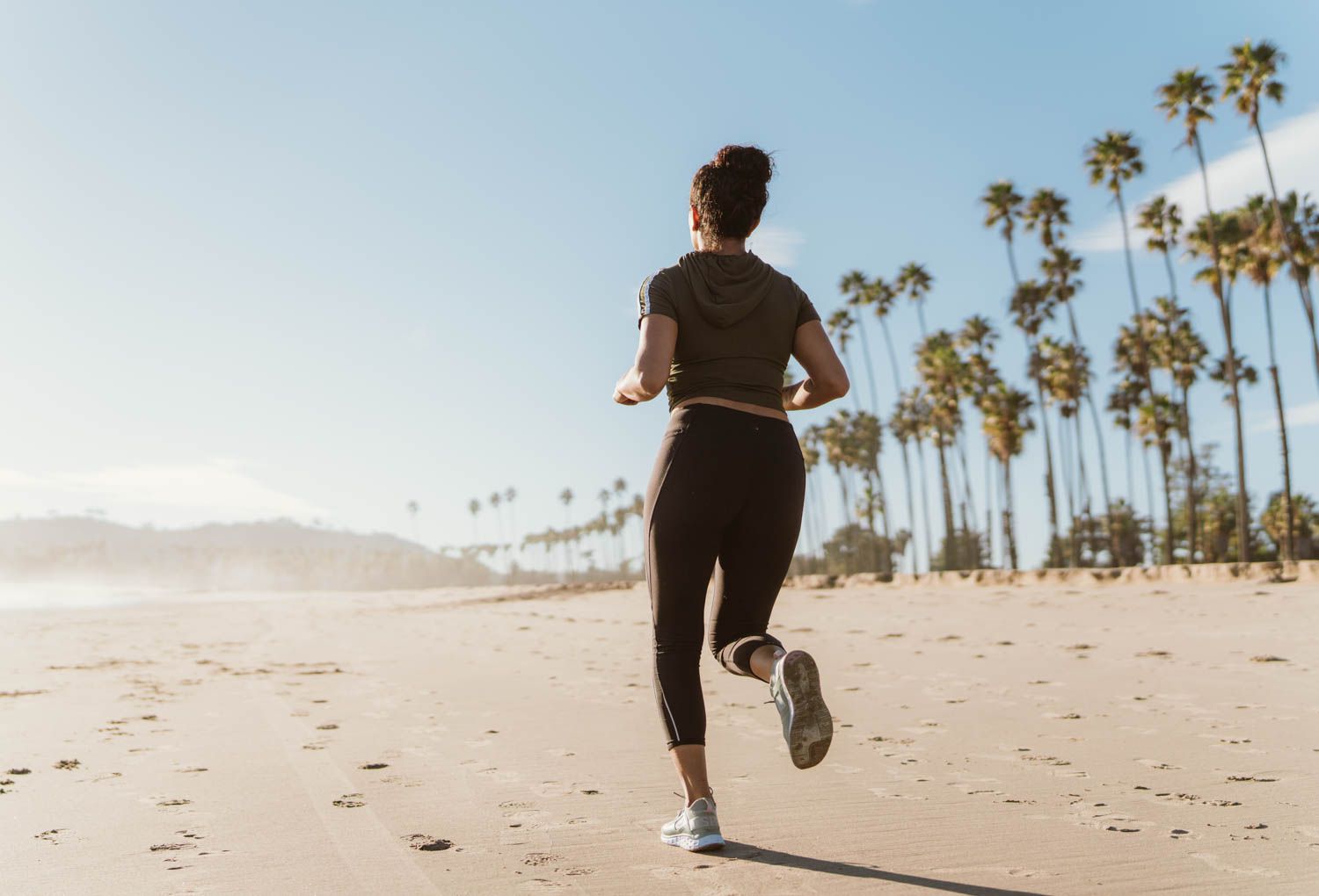 Woman running on beach for cardio exercise