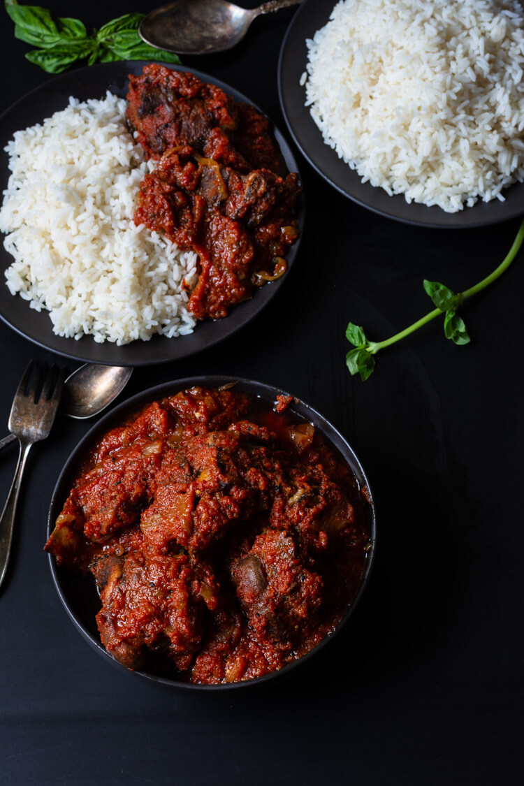 Rice and stew made with steamed white rice, tomatoes, red bell pepper, beef, onions, vegetable oil and curry powder - RoyalRoom Restaurant Lagos